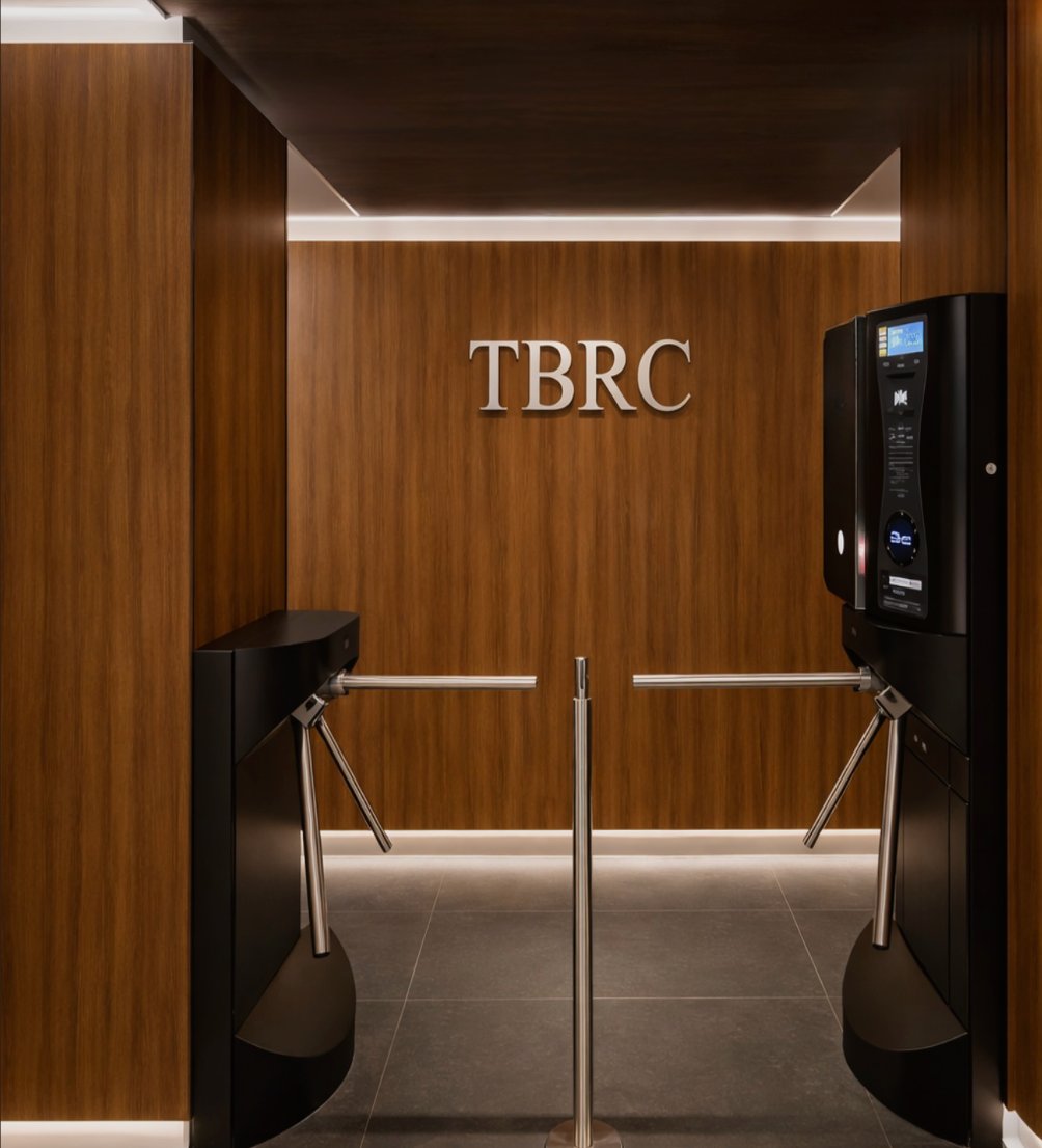 TBRC premium restroom entrance with turnstiles and wood panelling